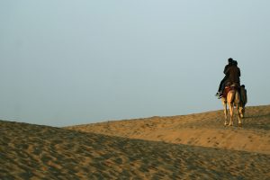 couple riding a camel in the desert- TravelPlacesIndia